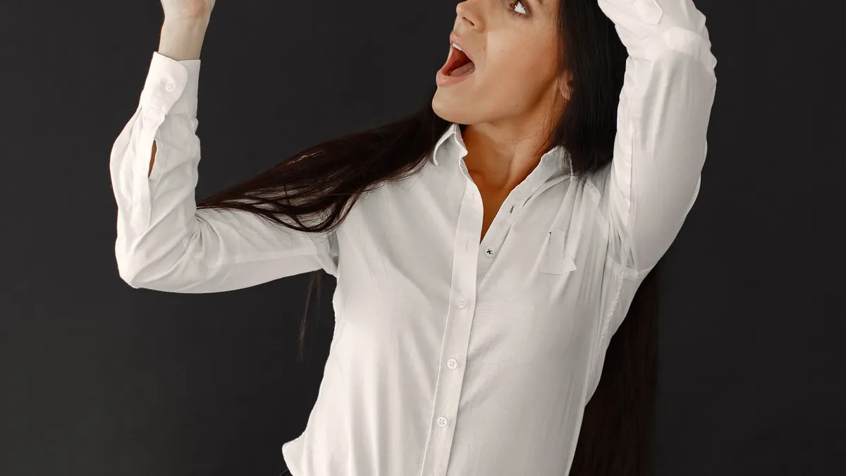 Empire Flippers vs Flippa: fees, vetting, and which sellers benefit from each — Woman with Sale Banner on Black Backgrou