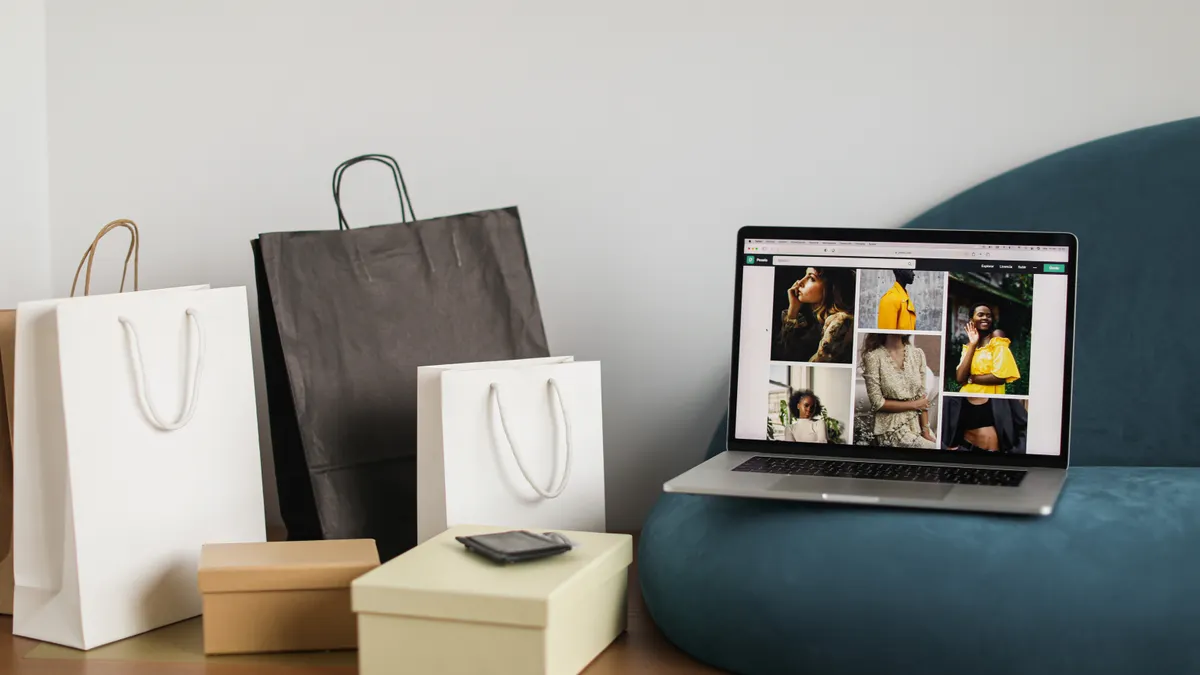 shopping bags and laptop displaying a product grid