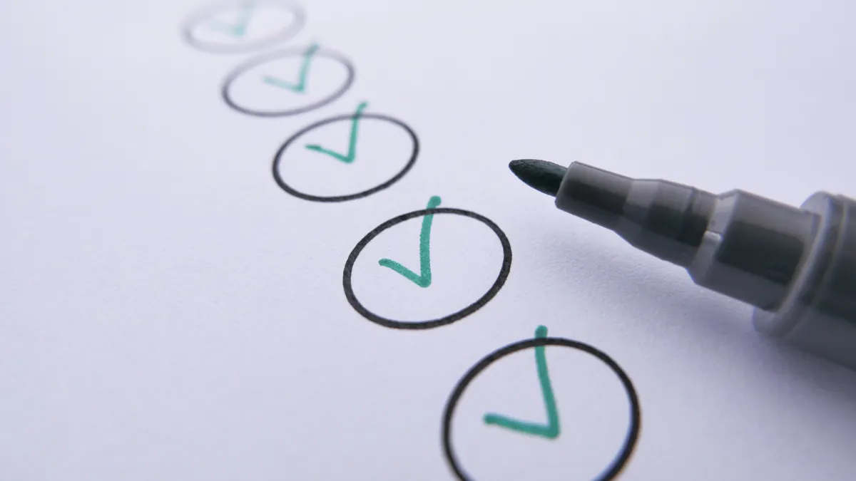 Checklist with checkmarks being reviewed