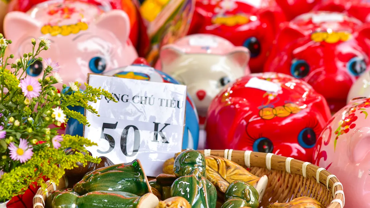 Quiet Light vs Empire Flippers: which broker fits $50k–$500k website sales — Vietnamese Market Stall with Colorful Piggy