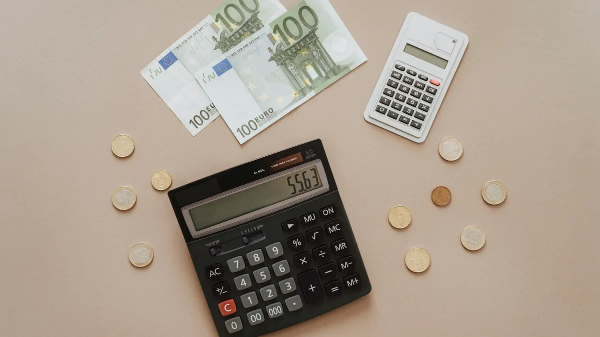 calculator with banknotes and coins