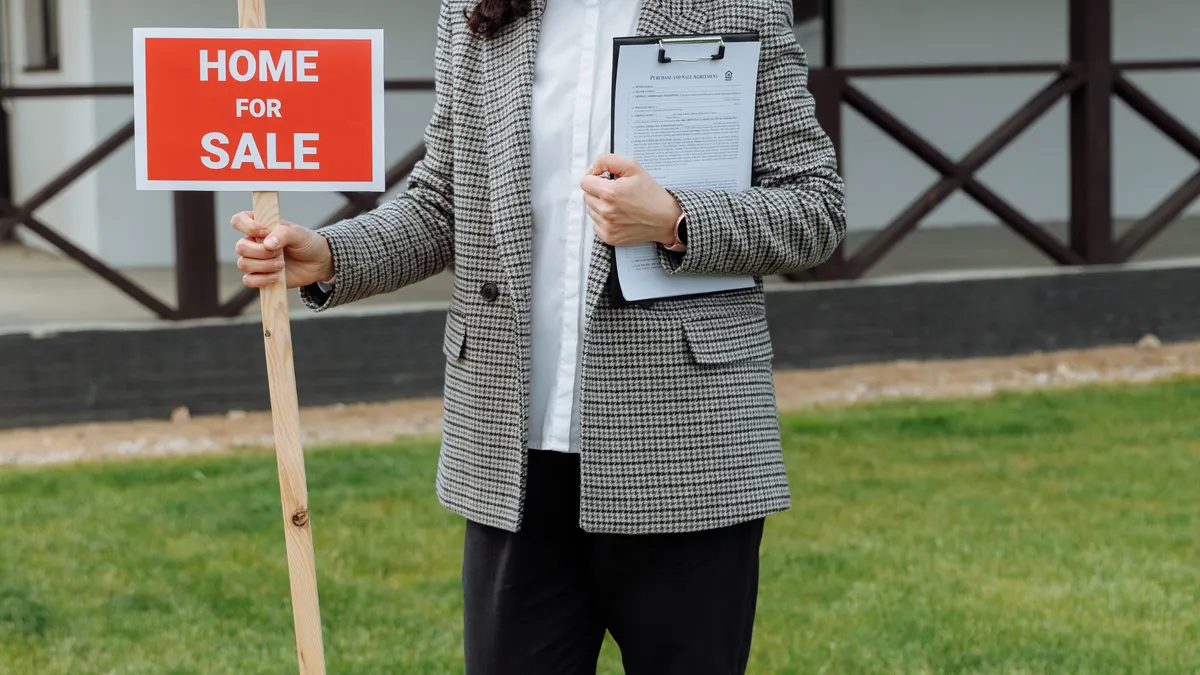 Where to sell a website: marketplace, broker and private-sale options by site size — Woman Holding a Home For Sale Sign